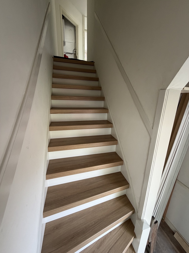Traprenovatie Zoetermeer met houtlook treden en witte stootborden